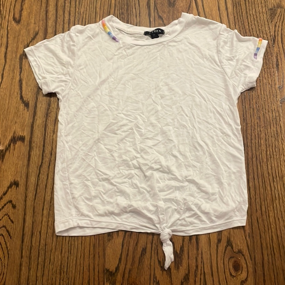 A fbz white top with little lines of rainbow pattern.